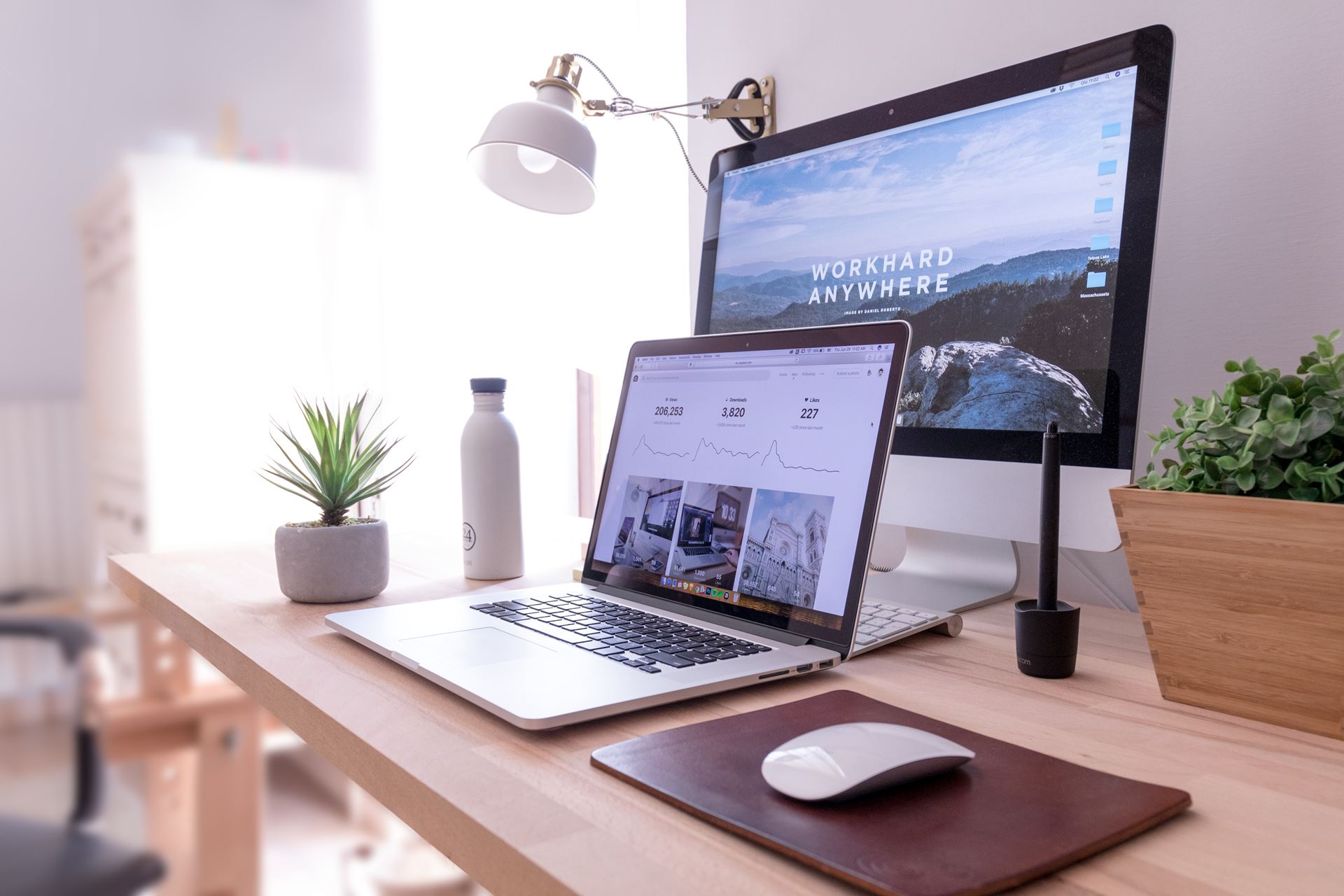 a desk with a laptop computer sitting on top of a wooden table